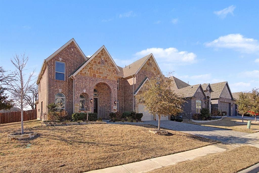 3409 Florence Drive, Corinth, TX 76210 Tudor house featuring brick siding and driveway