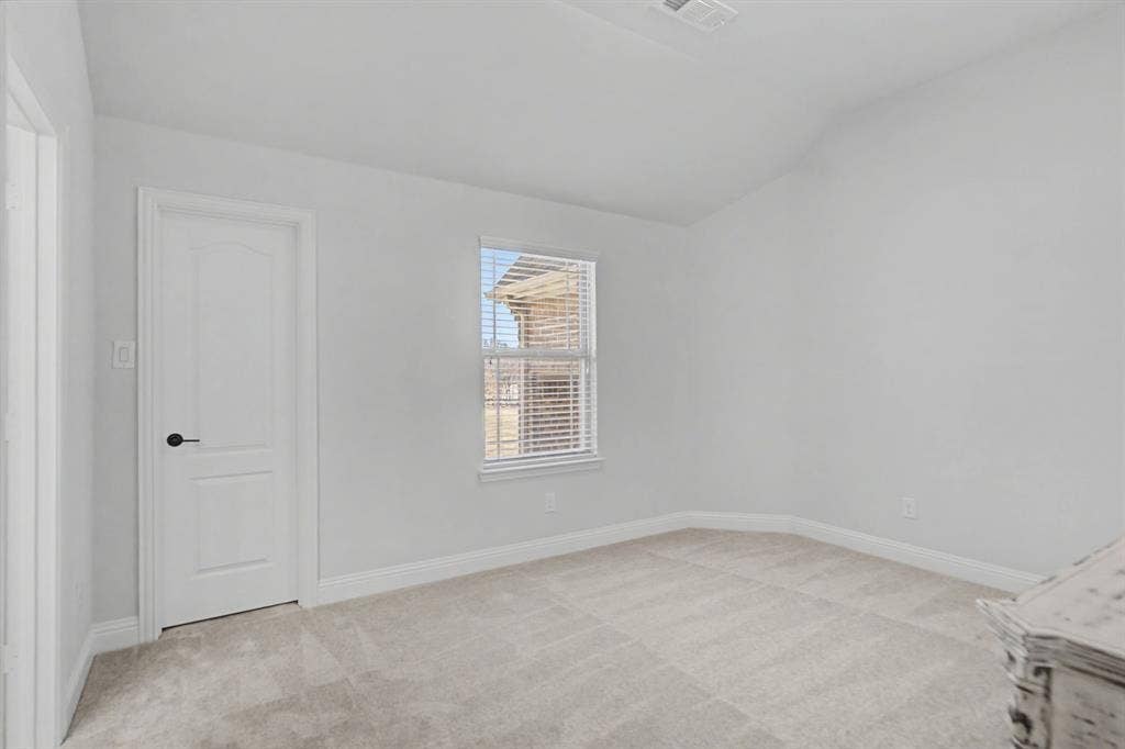 3409 Florence Drive, Corinth, TX 76210 Bedroom with light carpet and vaulted ceiling