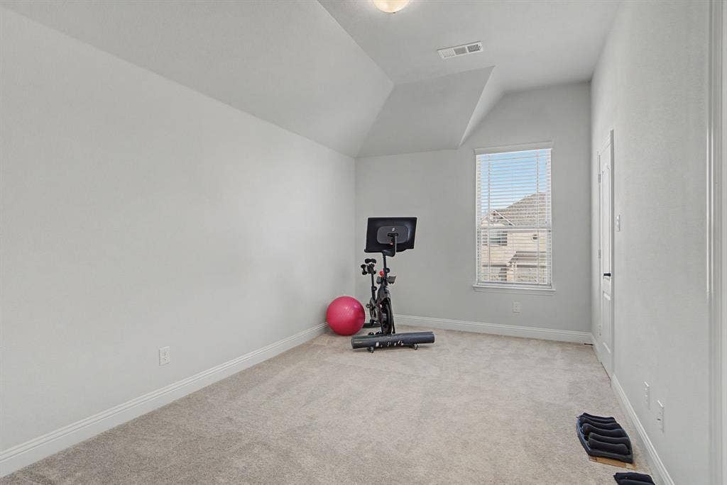 3409 Florence Drive, Corinth, TX 76210 Carpeted bedroom with baseboards and vaulted ceiling