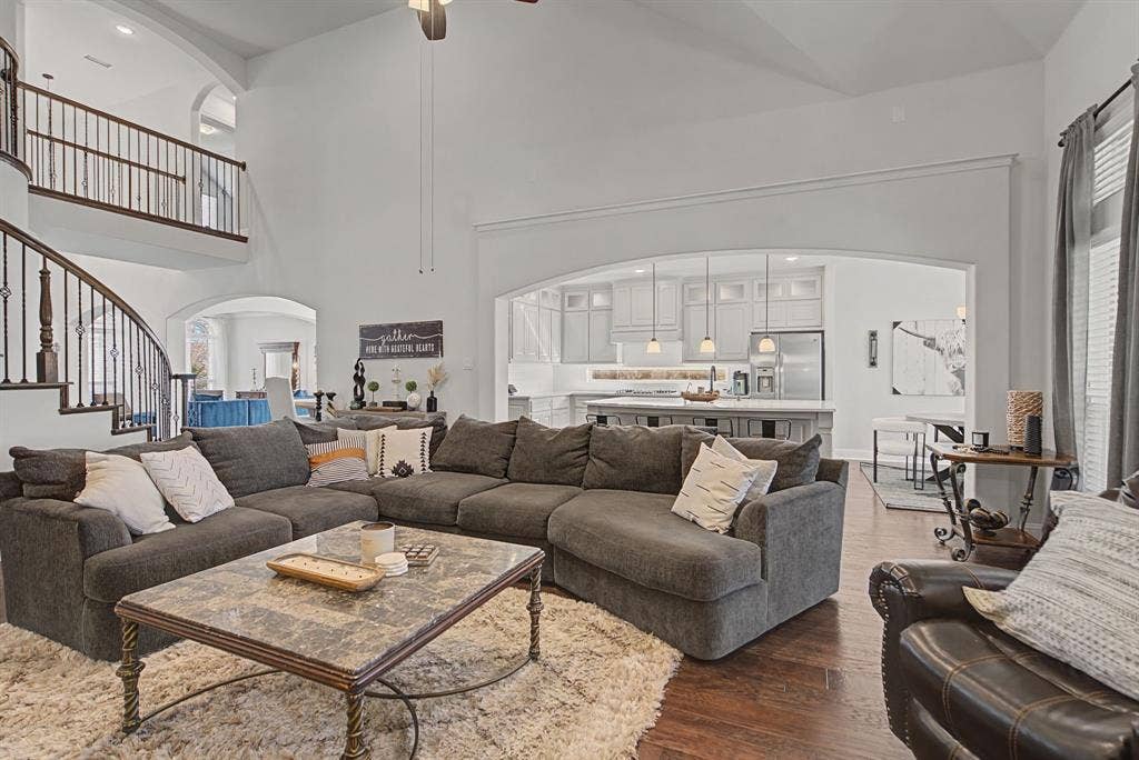 3409 Florence Drive, Corinth, TX 76210 Living room featuring arched walkways, a ceiling fan, dark wood-style floors, and vaulted ceiling