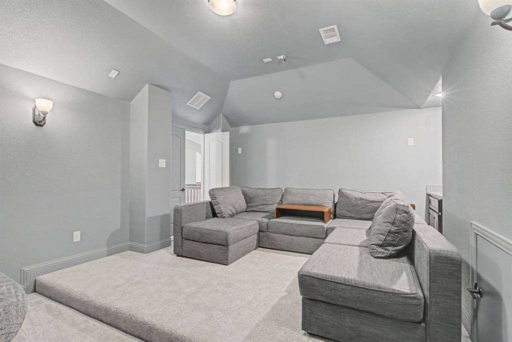3409 Florence Drive, Corinth, TX 76210 Home theater featuring carpet and vaulted ceiling