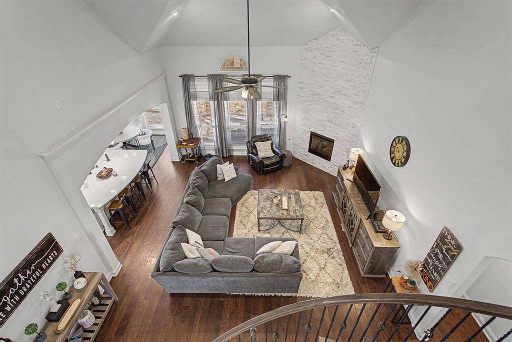 3409 Florence Drive, Corinth, TX 76210 Living room featuring a fireplace, dark wood-type flooring, a ceiling fan, and vaulted ceiling