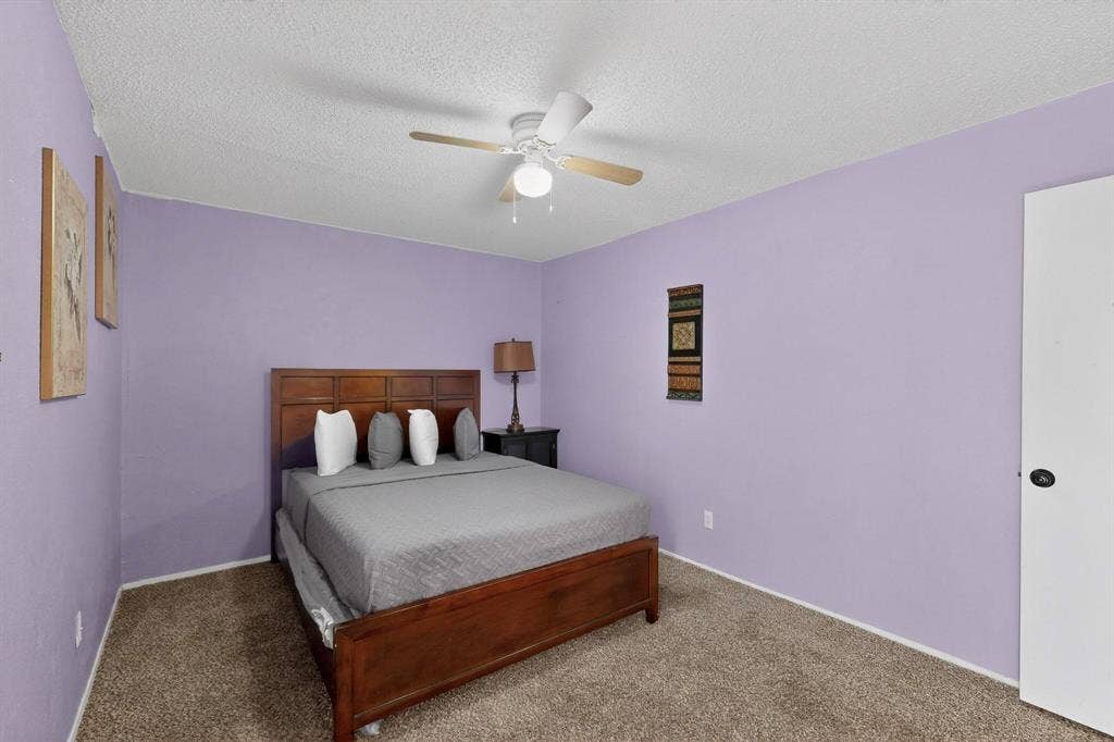 2315 Blue Sage Lane, Arlington, TX 76014 Bedroom with ceiling fan, a textured ceiling, and carpet floors