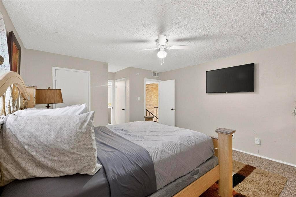2315 Blue Sage Lane, Arlington, TX 76014 Bedroom with a textured ceiling, ceiling fan, and carpet flooring