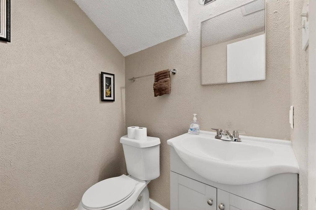 2315 Blue Sage Lane, Arlington, TX 76014 Half bathroom with vanity and a textured wall