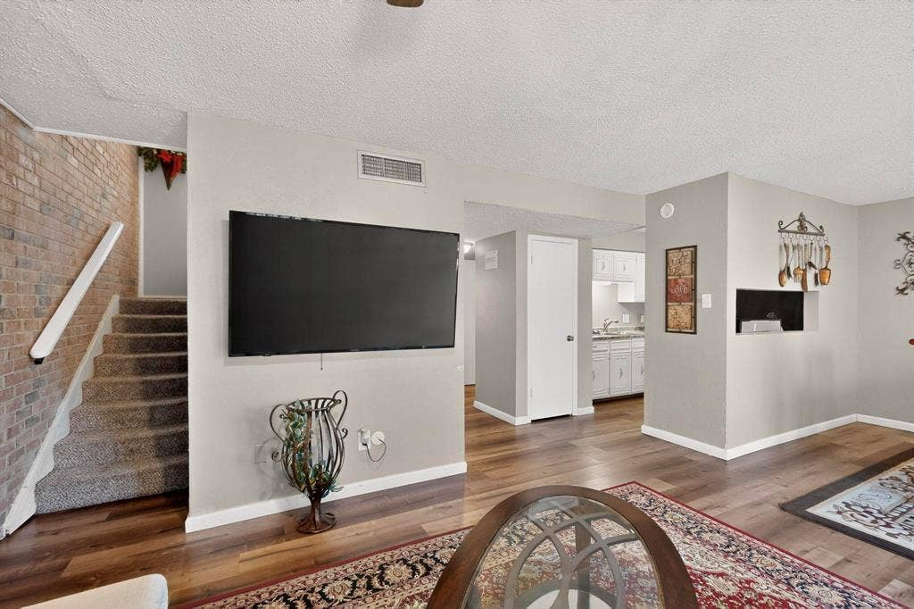 2315 Blue Sage Lane, Arlington, TX 76014 Living area with a textured ceiling and dark wood finished floors
