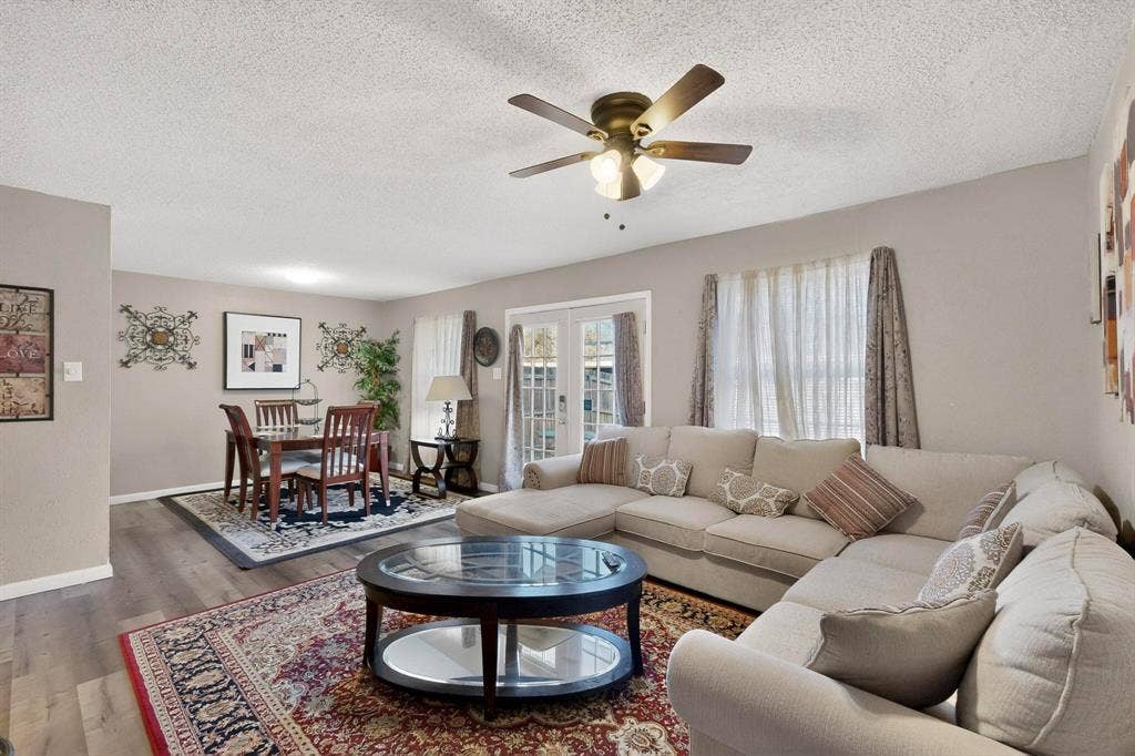 2315 Blue Sage Lane, Arlington, TX 76014 Living area with wood finished floors, french doors, a textured ceiling, and a ceiling fan