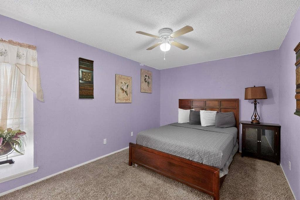 2315 Blue Sage Lane, Arlington, TX 76014 Carpeted bedroom with a textured ceiling and ceiling fan
