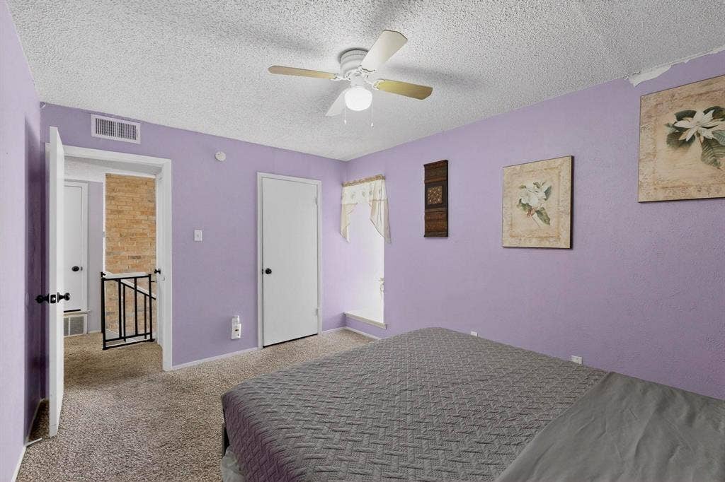 2315 Blue Sage Lane, Arlington, TX 76014 Carpeted bedroom featuring a textured ceiling and ceiling fan