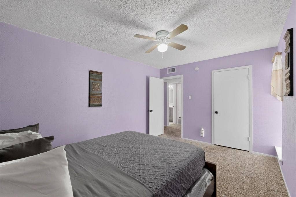 2315 Blue Sage Lane, Arlington, TX 76014 Bedroom featuring carpet, a textured ceiling, and a ceiling fan