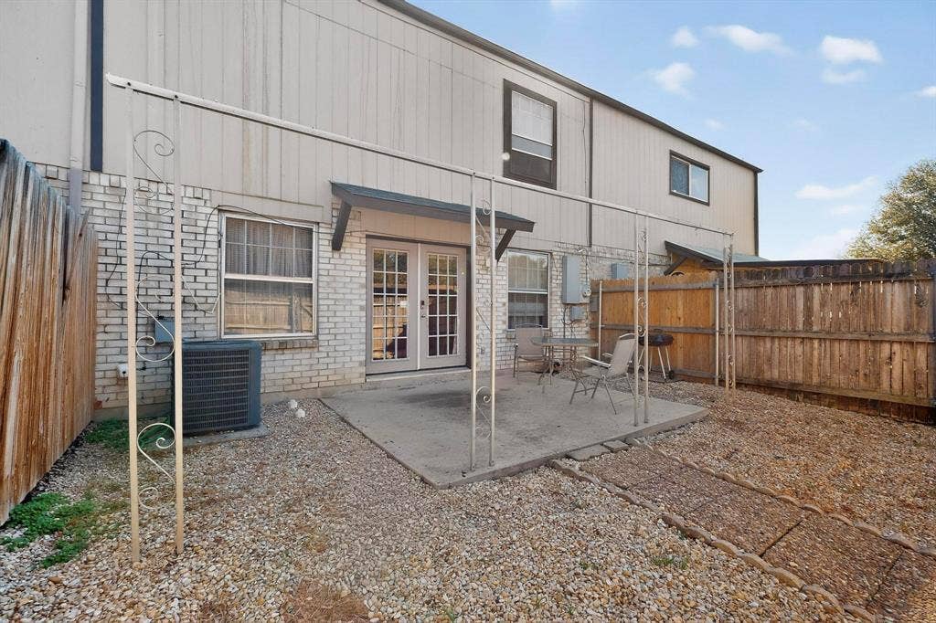 2315 Blue Sage Lane, Arlington, TX 76014 Back of property with a fenced backyard, french doors, a patio, and brick siding