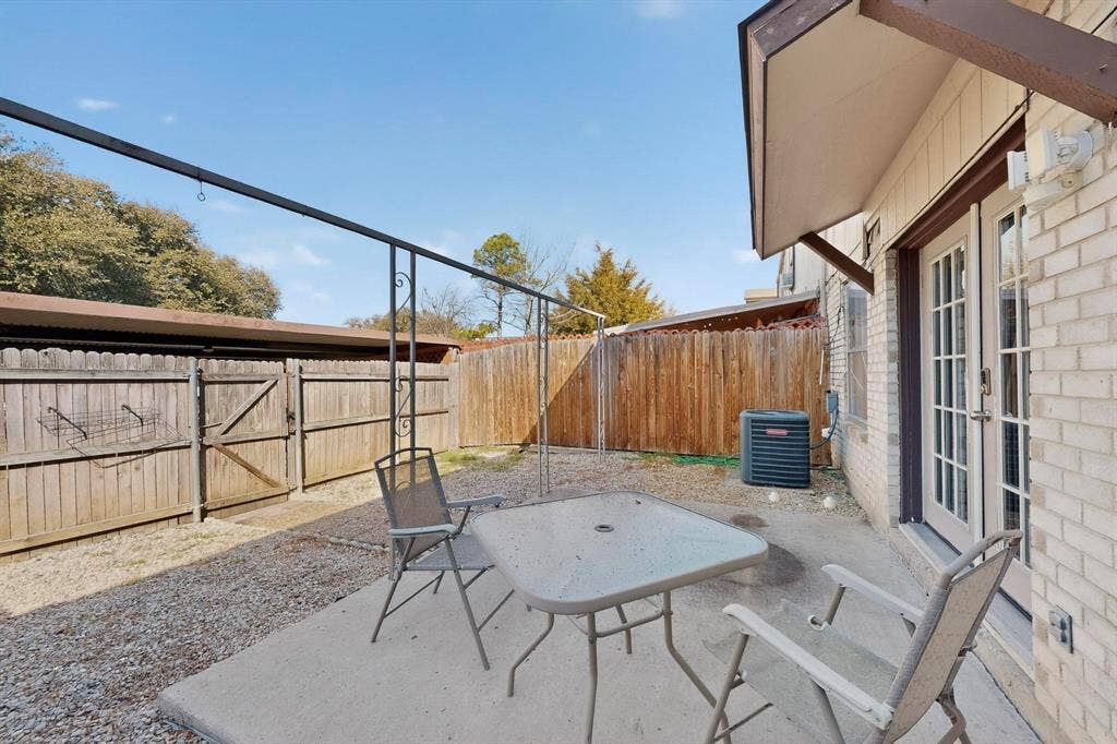 2315 Blue Sage Lane, Arlington, TX 76014 Fenced backyard with french doors and a patio area