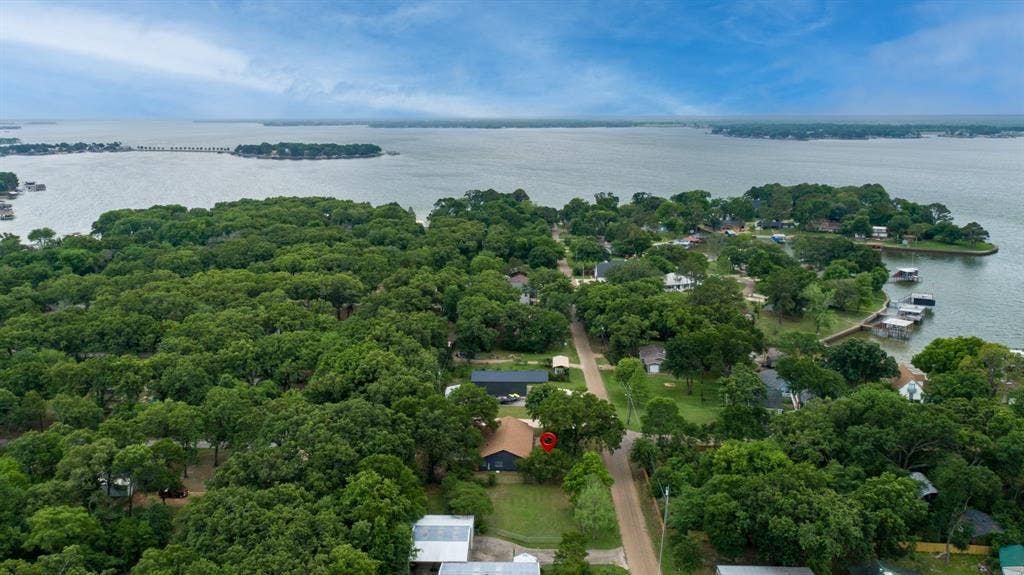 129 King Arthur Road, Mabank, TX 75156 This aerial view showcases the property nestled within a wooded area, offering a serene environment