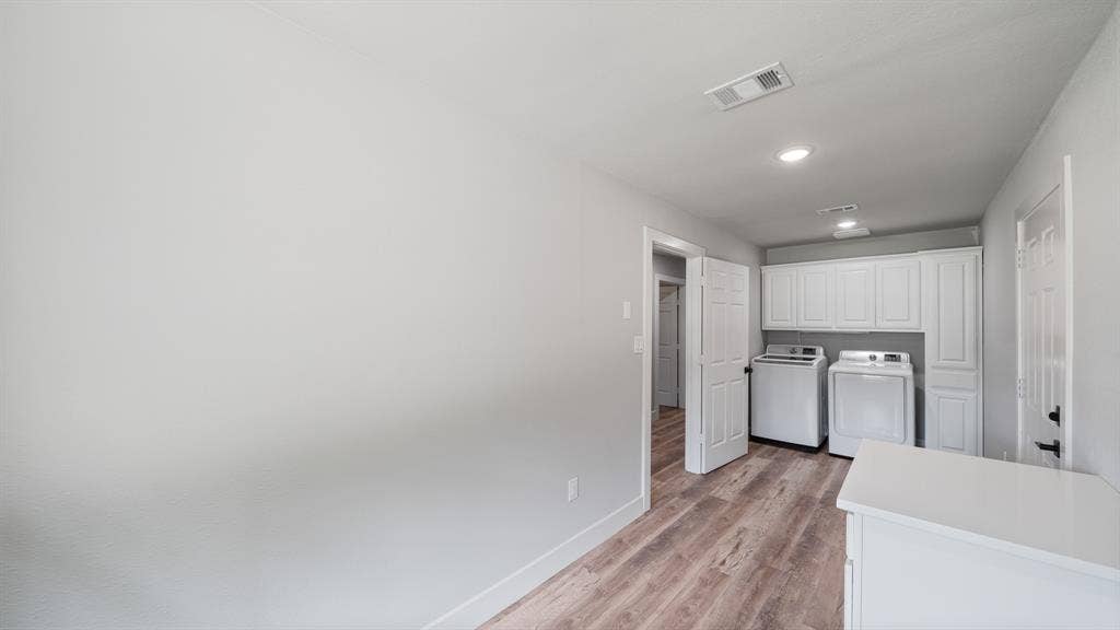 129 King Arthur Road, Mabank, TX 75156 Laundry area featuring wood-look flooring, white cabinetry, recessed lighting, and a white countertop