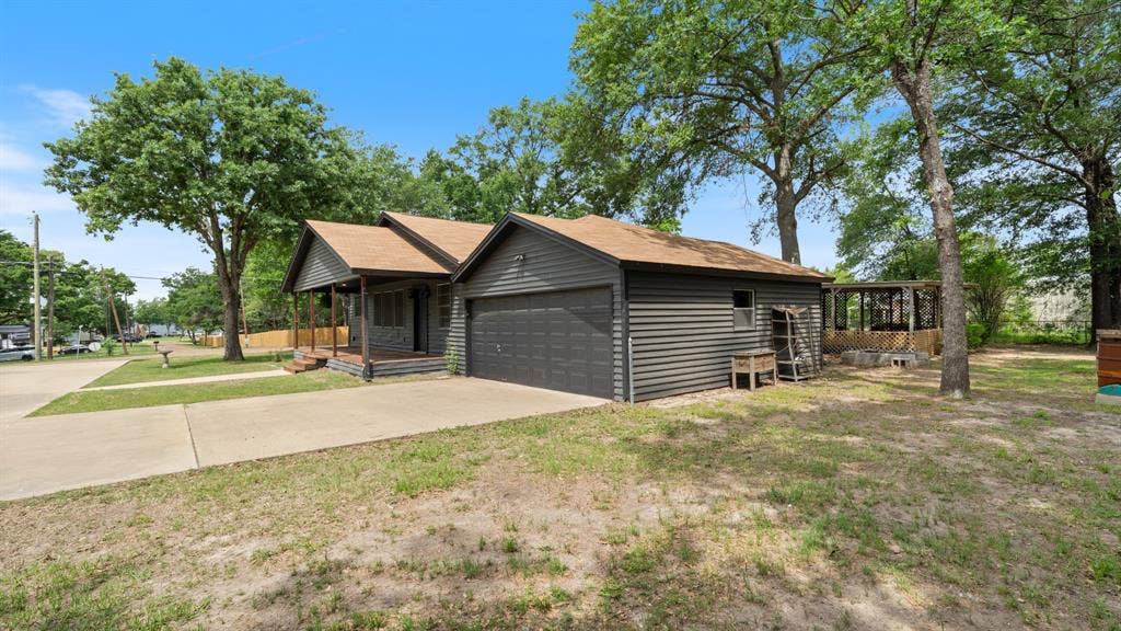 129 King Arthur Road, Mabank, TX 75156 The property features a concrete driveway, a front porch, and an attached garage