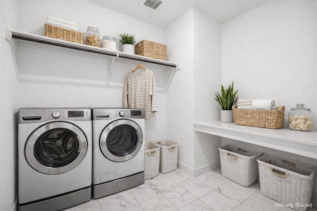 648 Courtyard Lane, Irving, TX 75039 2nd floor Laundry area with separate washer and dryer and light marble finish flooring