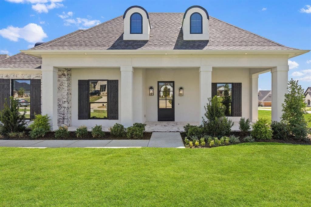 3333 Bridgegate Avenue, Northlake, TX 76247 French Colonial exterior featuring a covered porch with square columns, white-painted brick accents, and a dark-framed glass paneled entry door