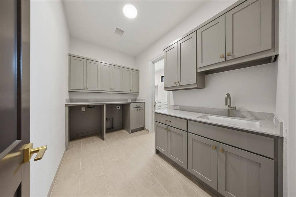 3333 Bridgegate Avenue, Northlake, TX 76247 Utility room featuring light gray cabinetry, light-toned tile flooring, recessed sink, and brushed nickel fixtures