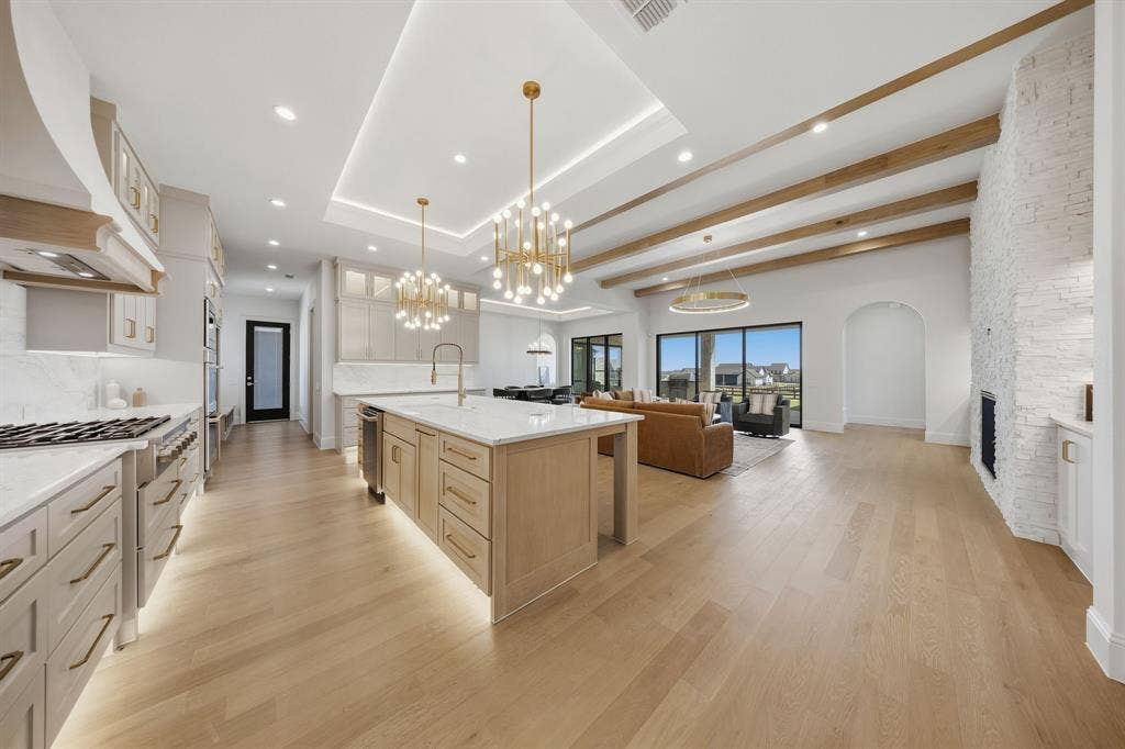 3333 Bridgegate Avenue, Northlake, TX 76247 Gourmet kitchen with a large island, stainless steel appliances, and under-cabinet lighting