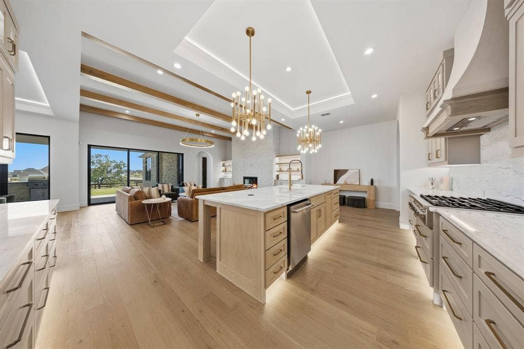 3333 Bridgegate Avenue, Northlake, TX 76247 Expansive kitchen with an oversized island, integrated stainless steel appliances, and abundant cabinetry