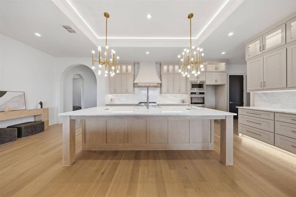 3333 Bridgegate Avenue, Northlake, TX 76247 Gourmet kitchen with a large island, wood-finish flooring, recessed lighting, and custom cabinetry