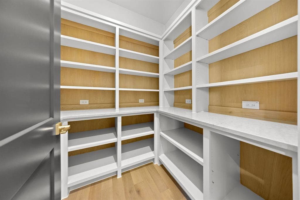 3333 Bridgegate Avenue, Northlake, TX 76247 Built-in shelving with wood-finish backing, white countertops, and wood-finish flooring