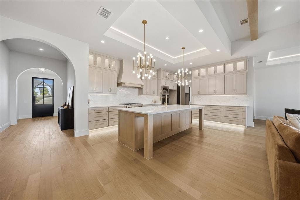 3333 Bridgegate Avenue, Northlake, TX 76247 Spacious kitchen featuring an expansive center island, integrated appliances, and extensive cabinetry with under-cabinet lighting