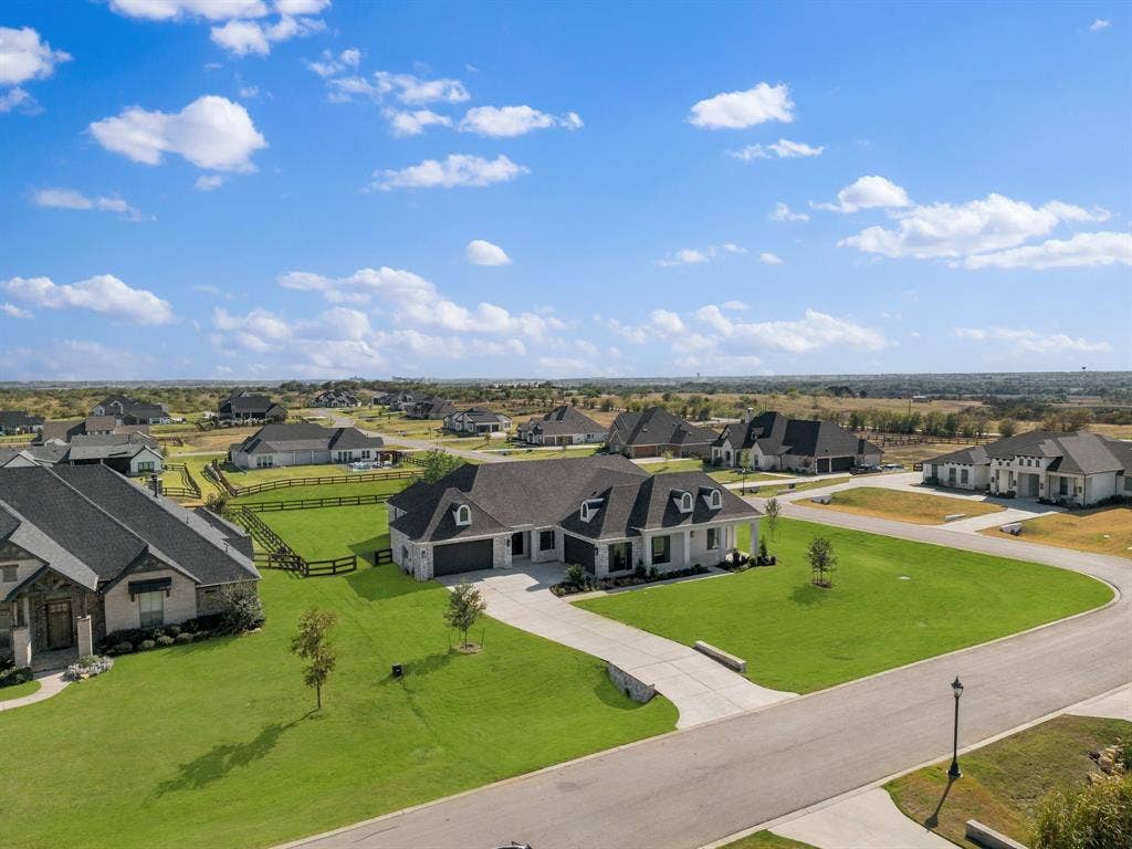 3333 Bridgegate Avenue, Northlake, TX 76247 Expansive property featuring a paved driveway, manicured lawn, and a black fenced backyard