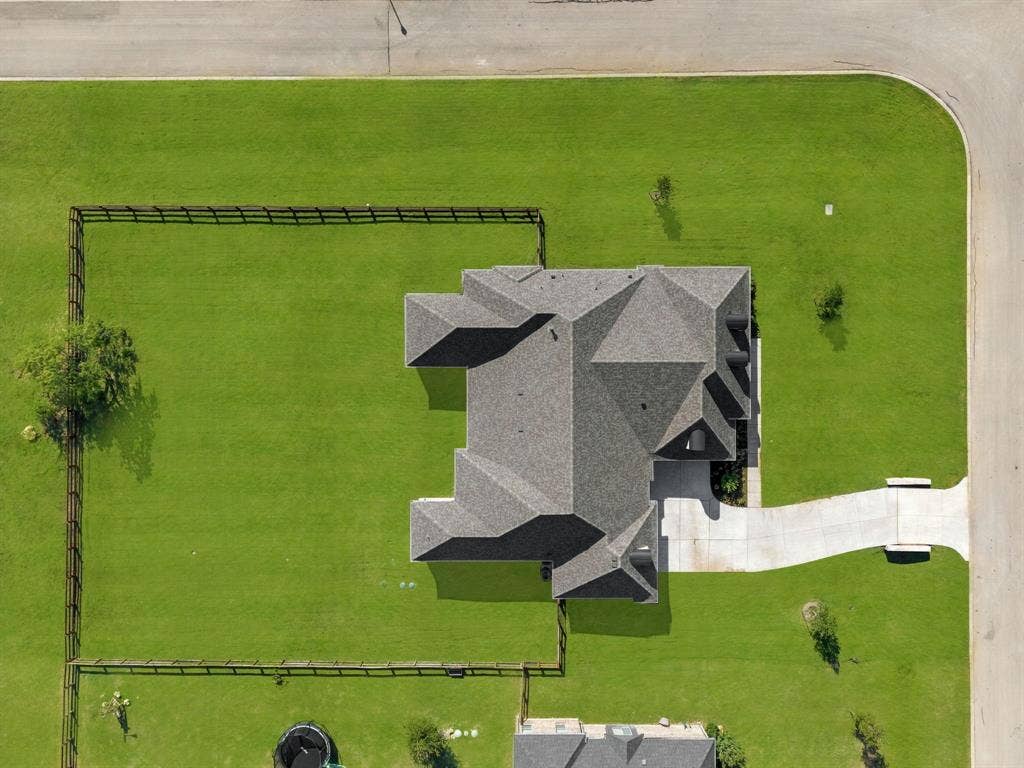3333 Bridgegate Avenue, Northlake, TX 76247 Expansive property featuring a multi-gabled roofline, concrete driveway, lush green lawn, and corner lot positioning