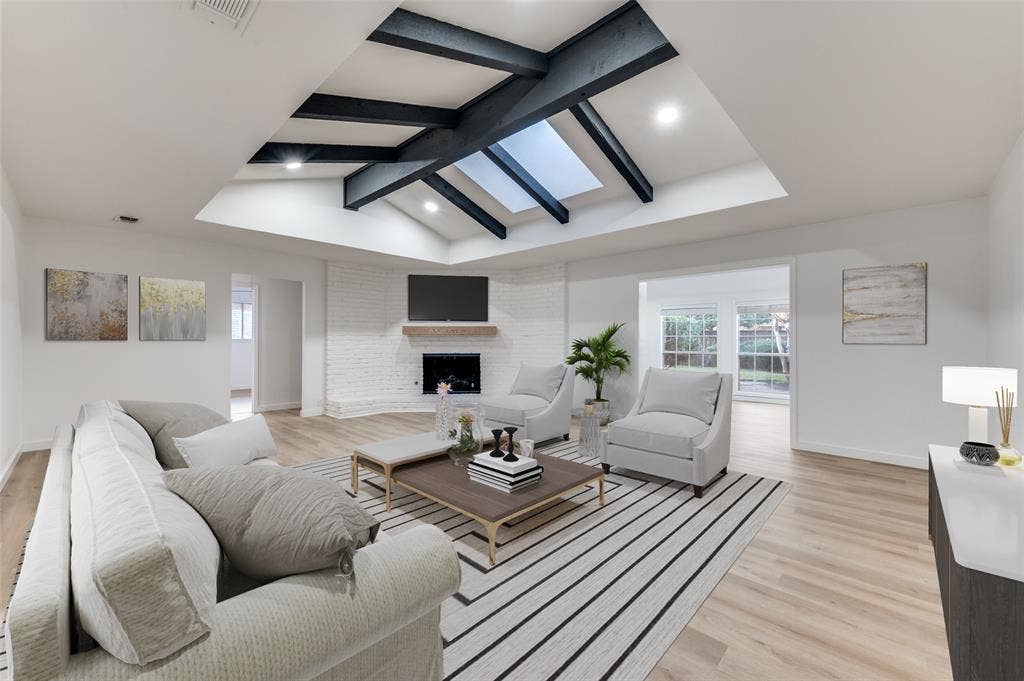 2601 Red Oak Lane, Plano, TX 75075 Vaulted living room featuring exposed beams, skylight, and a painted brick fireplace with custom white oak mantel.