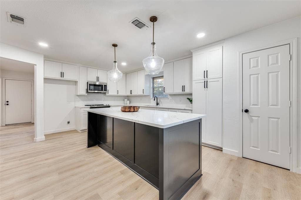 2601 Red Oak Lane, Plano, TX 75075 It houses two pantries, one with pull-out drawers and outlets for smaller appliances.