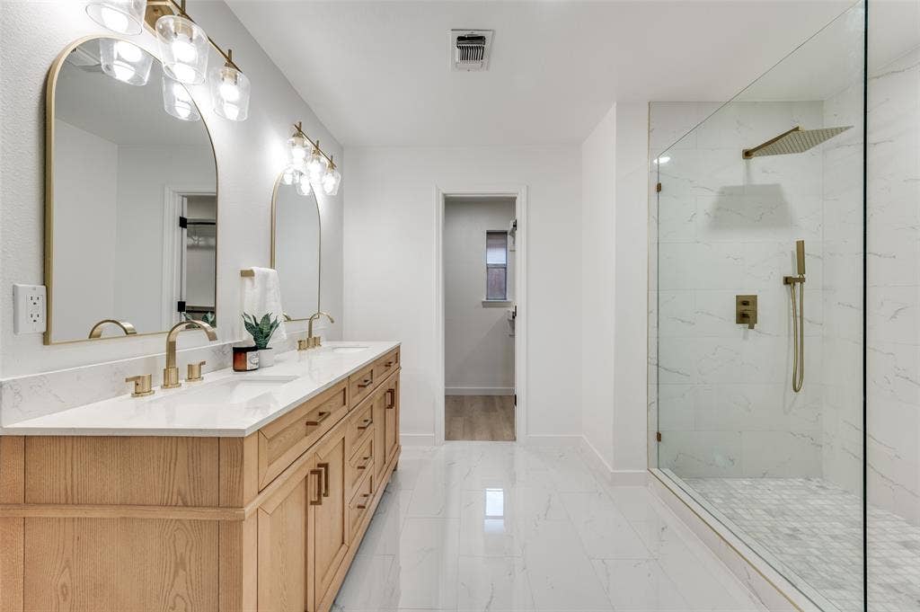 2601 Red Oak Lane, Plano, TX 75075 Spa-inspired primary bath featuring dual sinks, marble-topped vanity, and oversized walk-in shower with rainfall head and body sprayer.