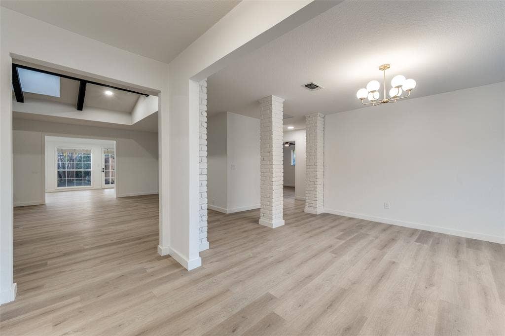 2601 Red Oak Lane, Plano, TX 75075 Light-filled interior featuring blonde, water-resistant LVP flooring and a clean, modern palette that reflects natural light beautifully.