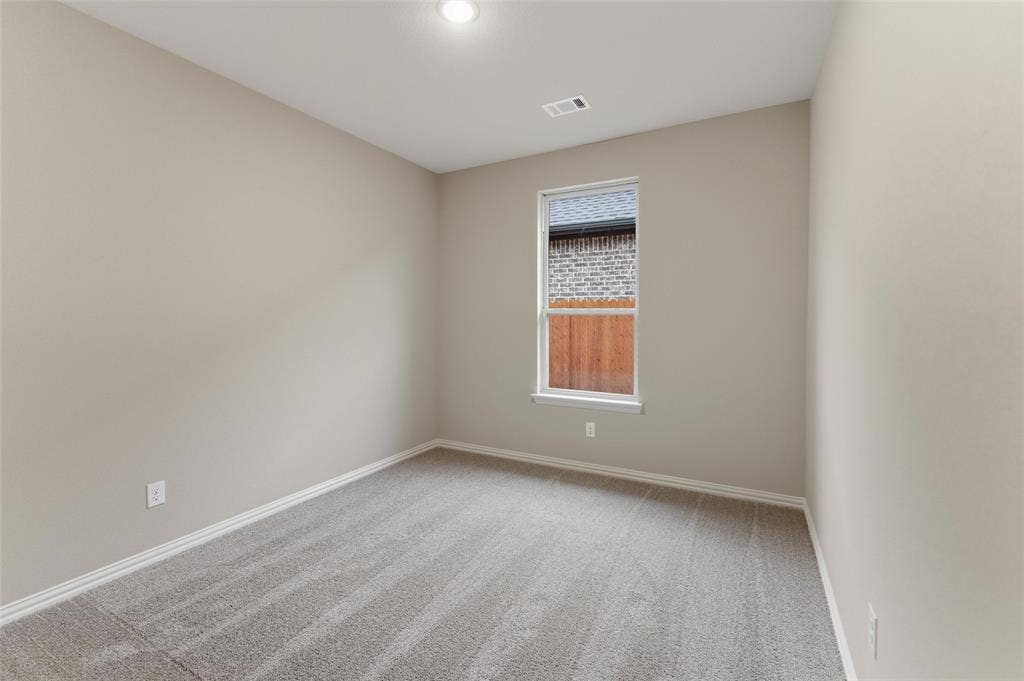 15056 Green Bluff Drive, Aledo, TX 76008 Interior room featuring neutral wall paint, gray carpet flooring, a single window, white trim, and a recessed ceiling light