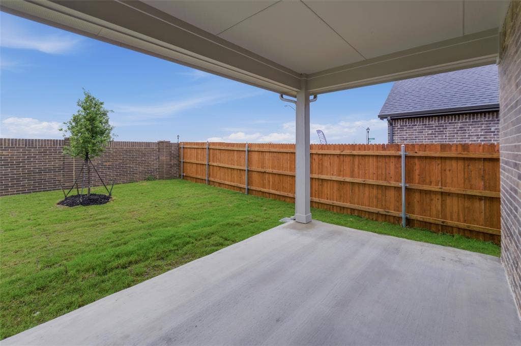 15056 Green Bluff Drive, Aledo, TX 76008 Covered patio with a concrete surface, overlooking a grassy yard