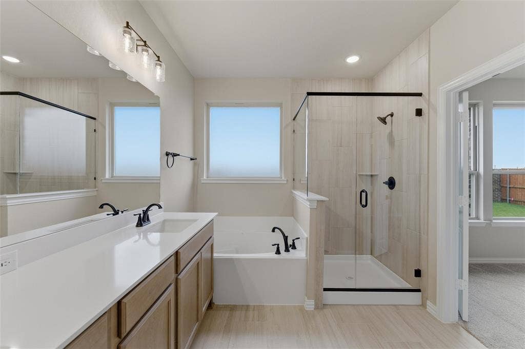 15056 Green Bluff Drive, Aledo, TX 76008 Bathroom featuring a double vanity with stone countertop, wood cabinetry, and matte black fixtures