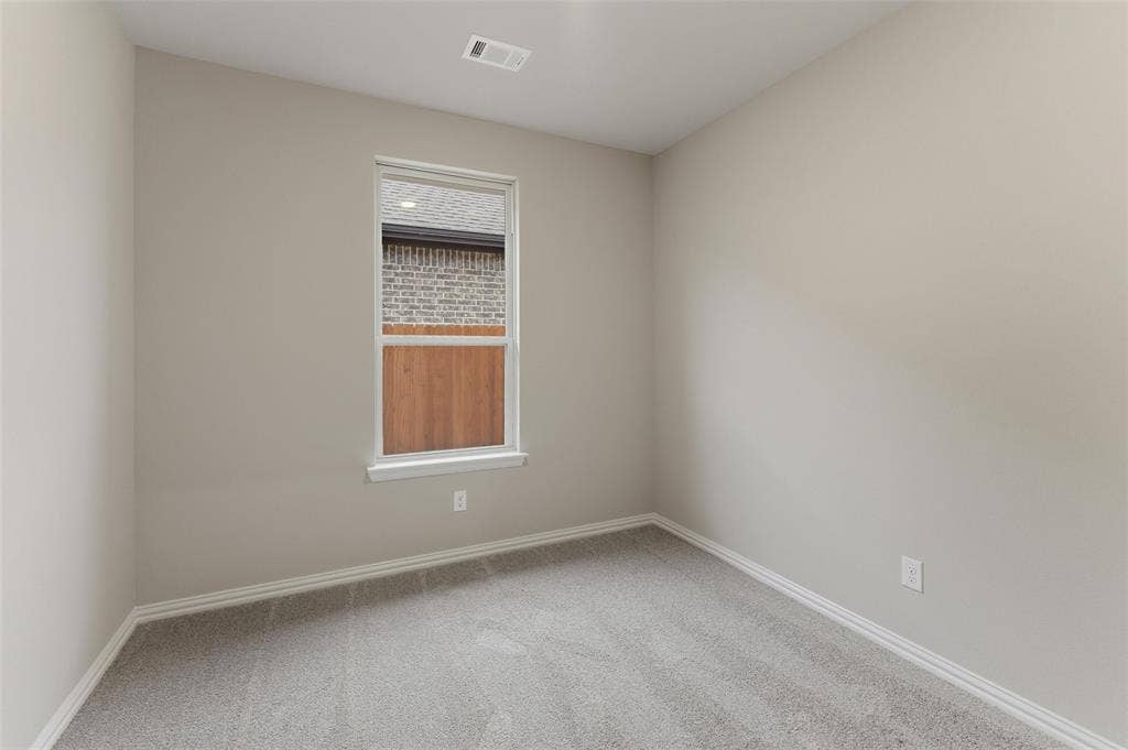 15056 Green Bluff Drive, Aledo, TX 76008 Neutral tone walls with white trim, light gray carpeting, and a double-pane window