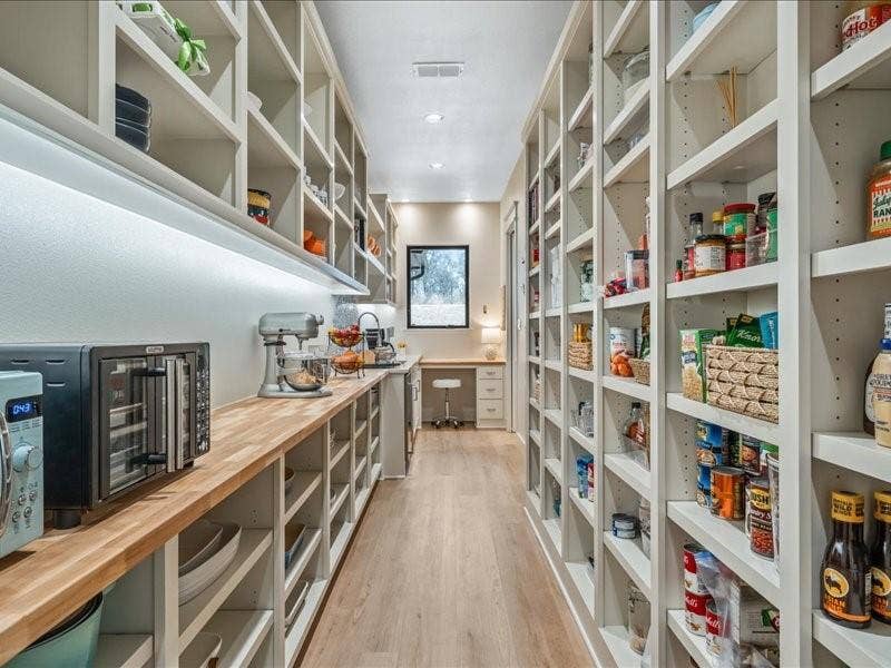 8701 Zebra Crossing, Larue, TX 75770 Hidden pantry and work space behind the kitchen. Dreamy.