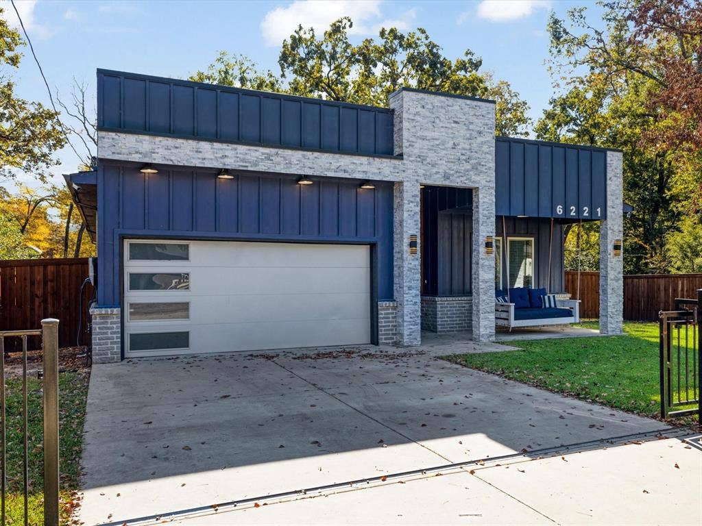 6221 Inca Drive, Mabank, TX 75156 View of front of home featuring board and batten siding, driveway, a garage, and a patio