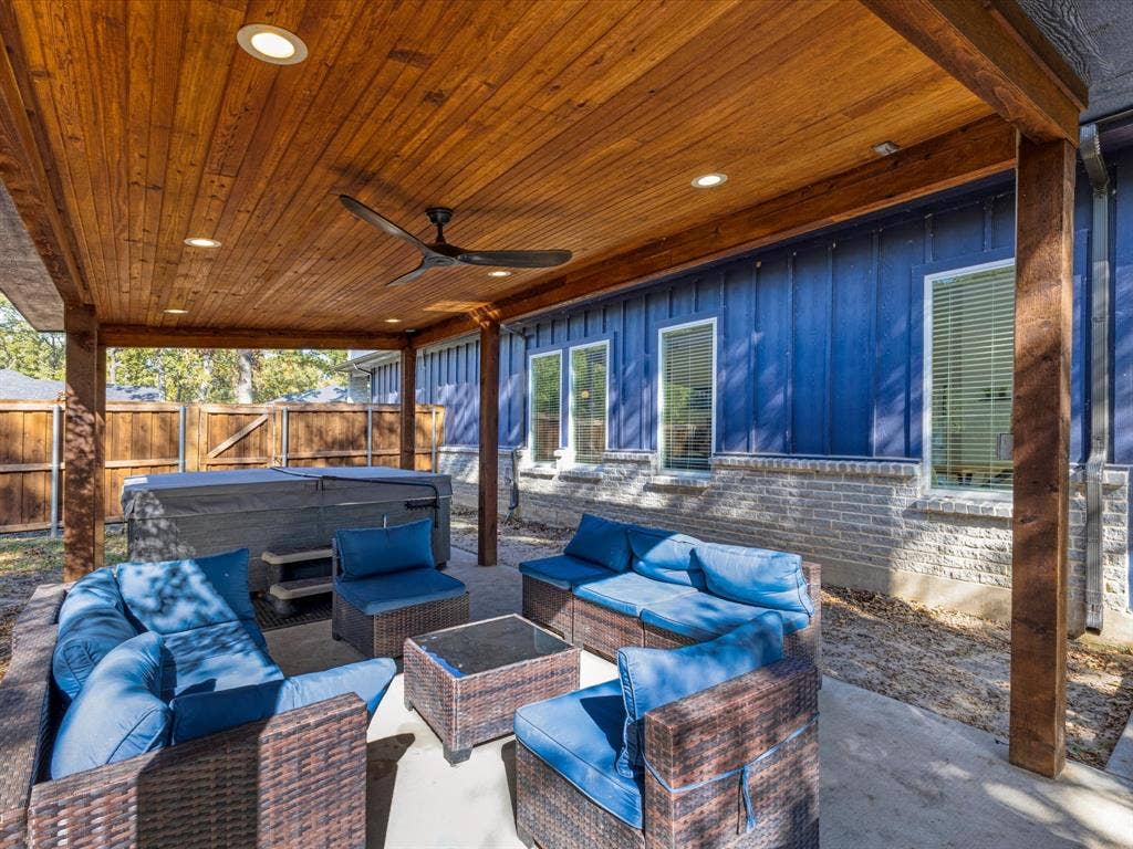 6221 Inca Drive, Mabank, TX 75156 Fenced backyard featuring an outdoor living space, a hot tub, a patio area, and ceiling fan