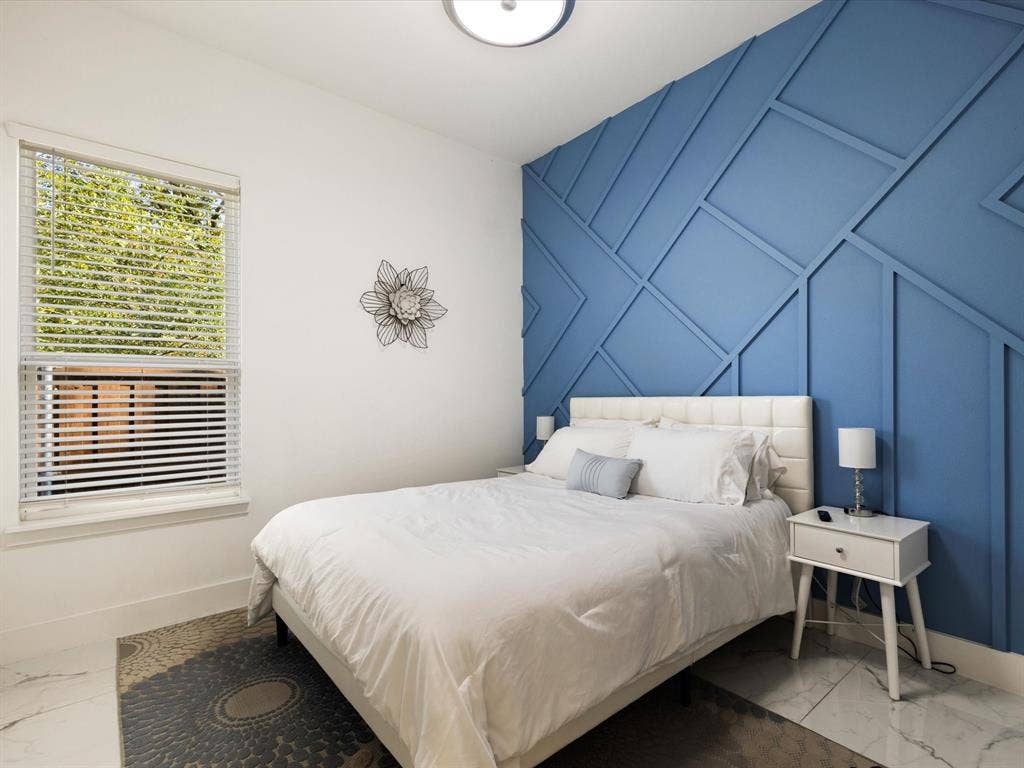 6221 Inca Drive, Mabank, TX 75156 Bedroom with marble look tile flooring, a decorative wall, and an accent wall
