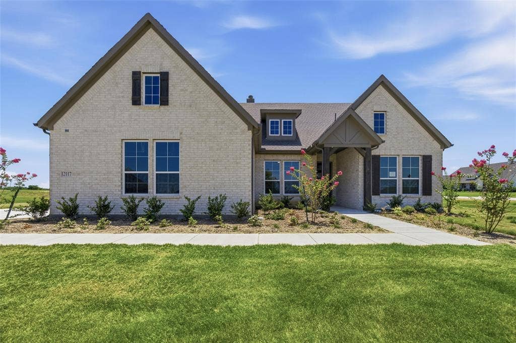 12117 Clastic Court, Krum, TX 76249 Cream brick exterior with dark trim and shutters