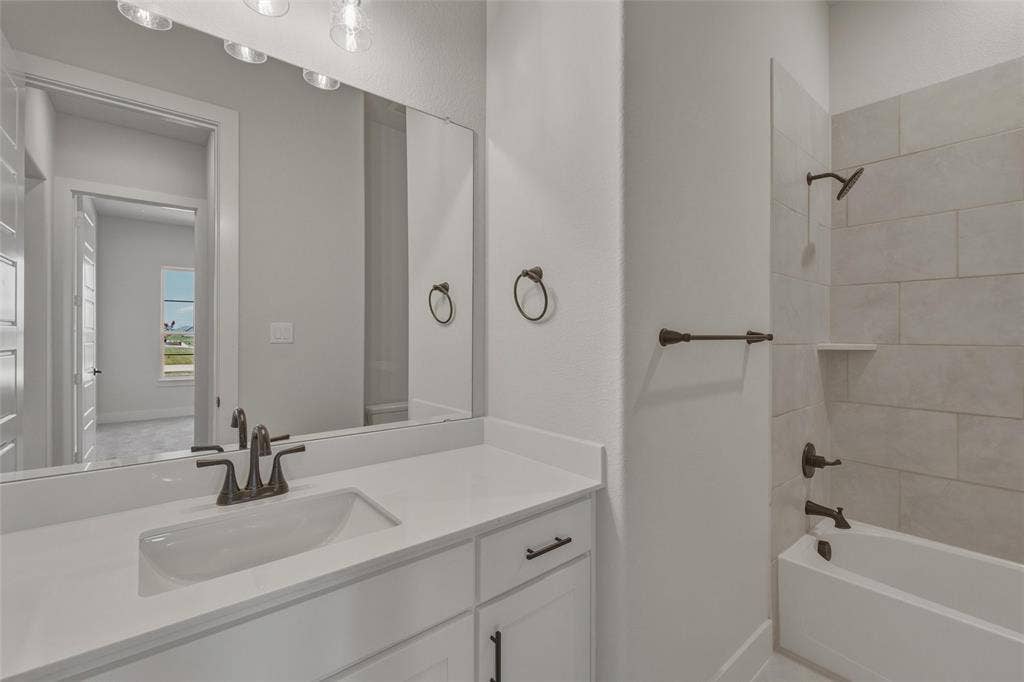 12117 Clastic Court, Krum, TX 76249 Bathroom featuring a single vanity with an undermount sink, a white countertop, and dark-finish hardware