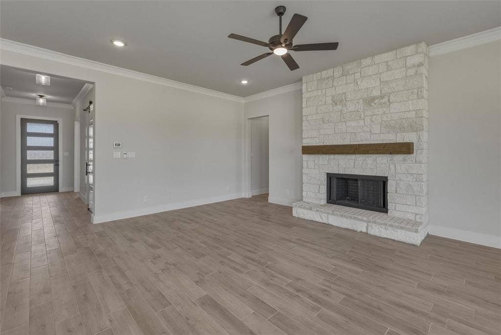 12117 Clastic Court, Krum, TX 76249 Living area featuring a stone fireplace with a wood mantel, a ceiling fan, recessed lighting, and wood-finish flooring