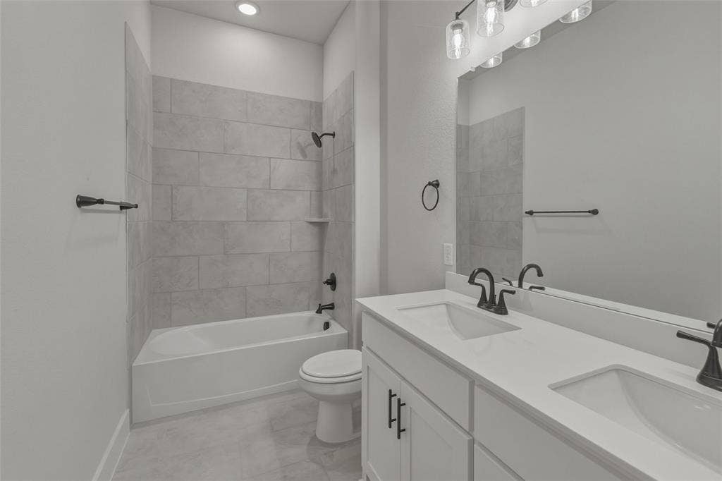 12117 Clastic Court, Krum, TX 76249 Bathroom with a dual vanity featuring white countertops and cabinetry, matte black fixtures, and a large wall-mounted mirror
