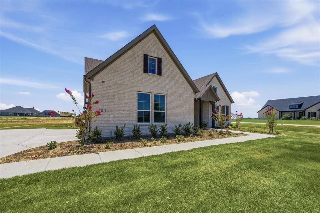 12117 Clastic Court, Krum, TX 76249 Light brick exterior with dark trim and shutters