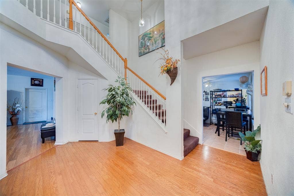 Entrance foyer featuring wood finished floors and a high ceiling