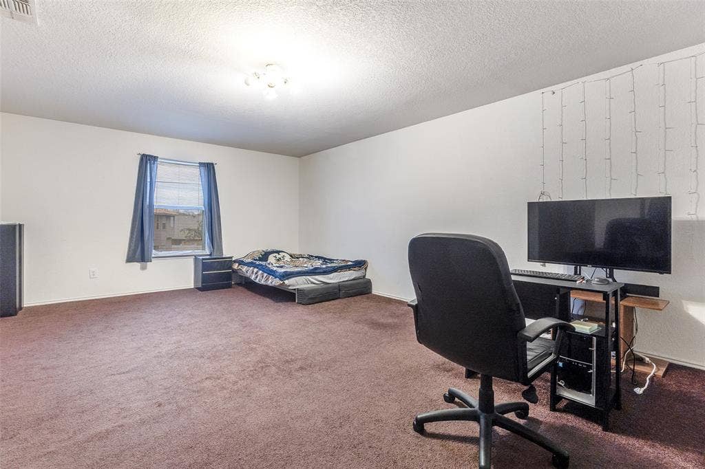 Office area with carpet and a textured ceiling
