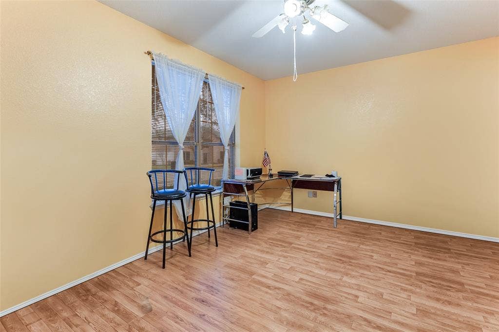 Office space featuring light wood-style floors and ceiling fan