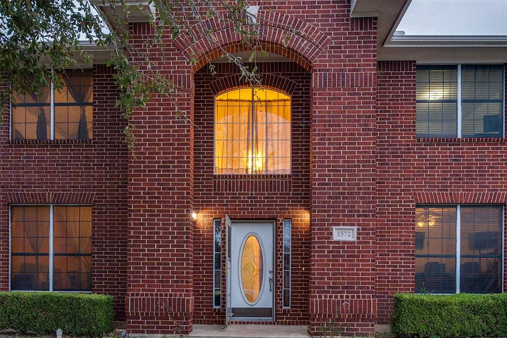 Entrance to property with brick siding